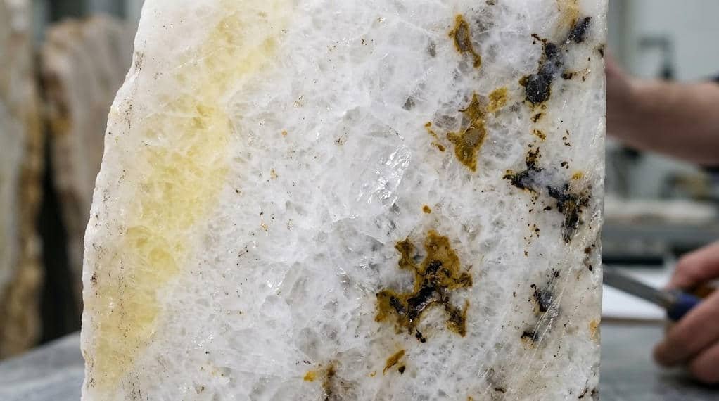 Natural impurities and variations in color within the raw stone material used for gua sha tools